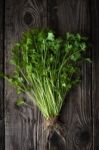 Green Celery With Roots On A Wooden Table Stock Photo