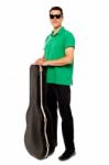 Young Male Holding Guitar Case Stock Photo