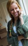 Young Beautiful Woman With Mobile Phone In Her New House Stock Photo