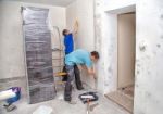 Two Men Applying Wallpaper Stock Photo