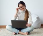 Beautiful Young Woman Working On Her Laptop At Home Stock Photo