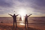 Happy Family With A Baby At The Sunset Stock Photo