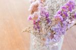 Beautiful Statice Flower Bouquet On Wooden Table Stock Photo