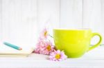 Notebook With A Pencil On The Table Next To Coffee And Flowers Stock Photo