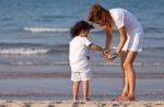 Asian Mom And Son On Beach Stock Photo