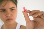 Young Woman Showing A Pill ,woman Healthcare Concept And Ideas Stock Photo