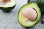 Avocado Cuts On Wooden Stock Photo