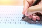 Businessman Hand Holding A Pen Working On Document Stock Photo