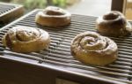 Iced Cinnamon Rolls On Shelf Stock Photo