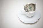 Dollars In White Coffee Cup Stock Photo