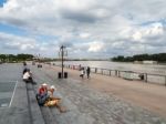 People Sitting By The River Garonne At Place De La Bourse In Bor Stock Photo