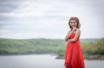 Beautiful Woman Wear Red Evening Dress Over Mountains And Rivers Stock Photo