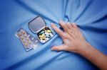 Closeup Hand Trying To Take Pills With Pain And Suffer Stock Photo