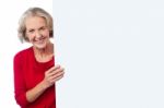 Aged Woman Holding Blank Ad Board Stock Photo