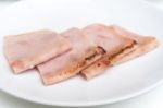 Sliced Ham On White Dish Stock Photo