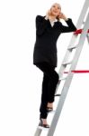 Woman Standing On Ladder Stock Photo