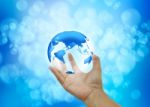 Human Hands Holding Blue Earth On Blue Background Stock Photo