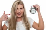 Girl Pointing Towards Old Fashioned Time Piece Stock Photo