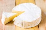 Camembert Cheese With Cut Wedge And Vintage Knife On Wooden Tabl Stock Photo