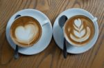 A Cup Of Coffee With Heart Pattern In A White Cup Stock Photo