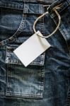 White Card On Wrinkled Jeans Stock Photo