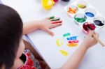 Asian Girl Doing Fingerprints Using Drawing Tools, Art Education Stock Photo