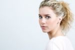 Beautiful Young Blonde Woman Looking At The Camera Stock Photo