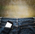 Blue Jeans With Cell Phone In A Pocket Background Stock Photo