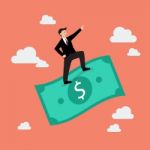 Businessman Standing On A Flying Money Stock Photo