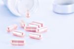 Closeup Of Pink Pills And Pill Bottle Stock Photo