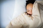 Close Up Of An Asian Man Face Sleeping On White Bed, Top View Stock Photo