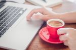 Red Coffee Cup With Notepad And Laptop Stock Photo