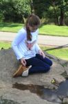 Girl Thinking On A Rock Stock Photo