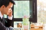 Business Man Using Mobile Phone While Sitting In The Coffee Shop Stock Photo