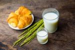 Croissant On Dish With Rice Milk And Ear Of Rice  On Old Wooden Stock Photo