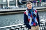 Handsome Man Posing Near Reiver Railing Stock Photo