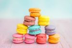 Colorful Macarons On A Pink Wooden Table Stock Photo