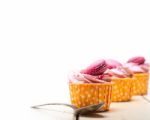 Pink Berry Cream Cupcake With Macaroon On Top Stock Photo