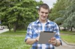 Man With Tablet Computer Relax In Park Stock Photo