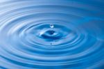 Water Drop Impact With Water Surface, Causing Rings On The Surface Stock Photo