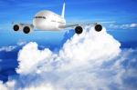 Airplane Flying In The Blue Sky Stock Photo