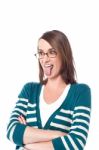 Wwoman Posing With Tongue Out And Arms Crossed Stock Photo