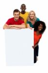 Smiling friends holding blank board Stock Photo