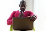 Handsome Young Man Working With His Laptop At Home Stock Photo