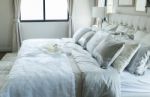 White And Grey Pillow On Bed Stock Photo