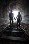 Couple Walking Together Through A Railway Tunnel Stock Photo