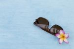 Sunglasses With Flower On Blue Background Stock Photo