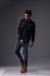 Casual Young Man In Black Leather Jacket And Denim Jeans Stock Photo