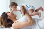 Mother And Baby Playing And Smiling At Home Stock Photo