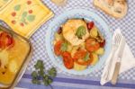 Fish With Potatoes And Tomato Stock Photo